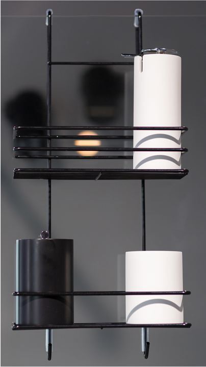 Black two-tier shower shelf holding bathroom accessories