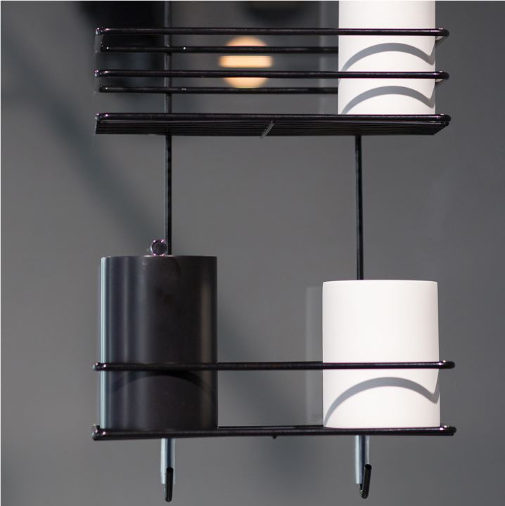 Black shower shelf with black and white containers